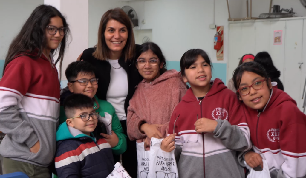 La secretaria Gisela Zamora junto a alumnos y directivos durante la entrega de lentes en las escuelas del distrito